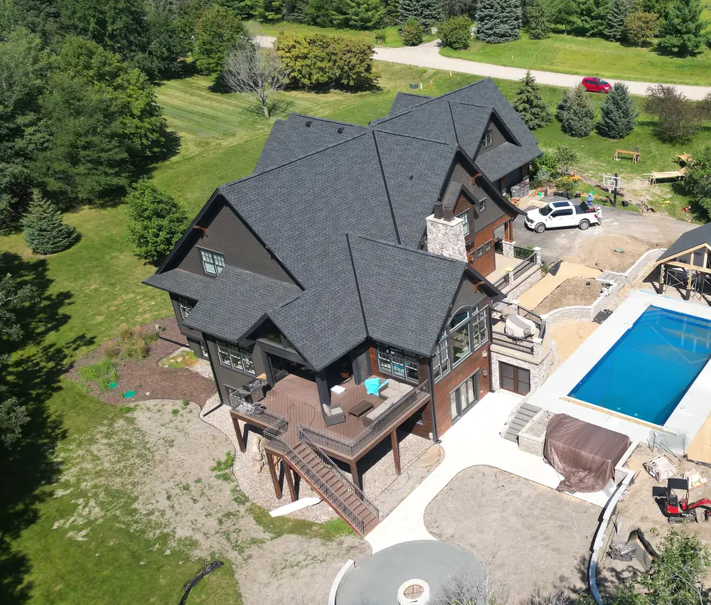 Aerial view of the renovated home at 6445 Nathan Road, Carver, with new charcoal exterior and roof.